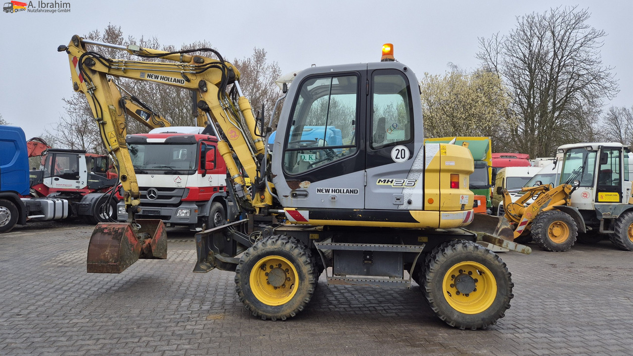 New Holland MH 2.6 Zustand gut, deutsche Maschine incl. Greifer und Dreservo - 轮式挖掘机:图1 New Holland MH 2.6 Zustand gut, deutsche Maschine incl. Greifer und Dreservo - 轮式挖掘机:图1